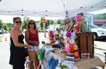 Peggy Firth, far left, and Cherl Bessey check out some of Amy Todd's handmade goods.
