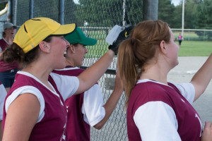 Members of the Kelsey's team celebrating a teammate's RBI in the championship game