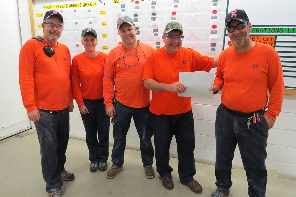 (From left) Glenn Pirie, Terry Lamb, Carson Inwood, Rene Landry, and Clayton Reid from the Kimberly-Clark Tissue Manufacturing Crew that initiated a donation drive to rally around coworkers while their spouses were receiving treatment for cancer. Rene Landry is being presented the funds by these representatives for the crew.