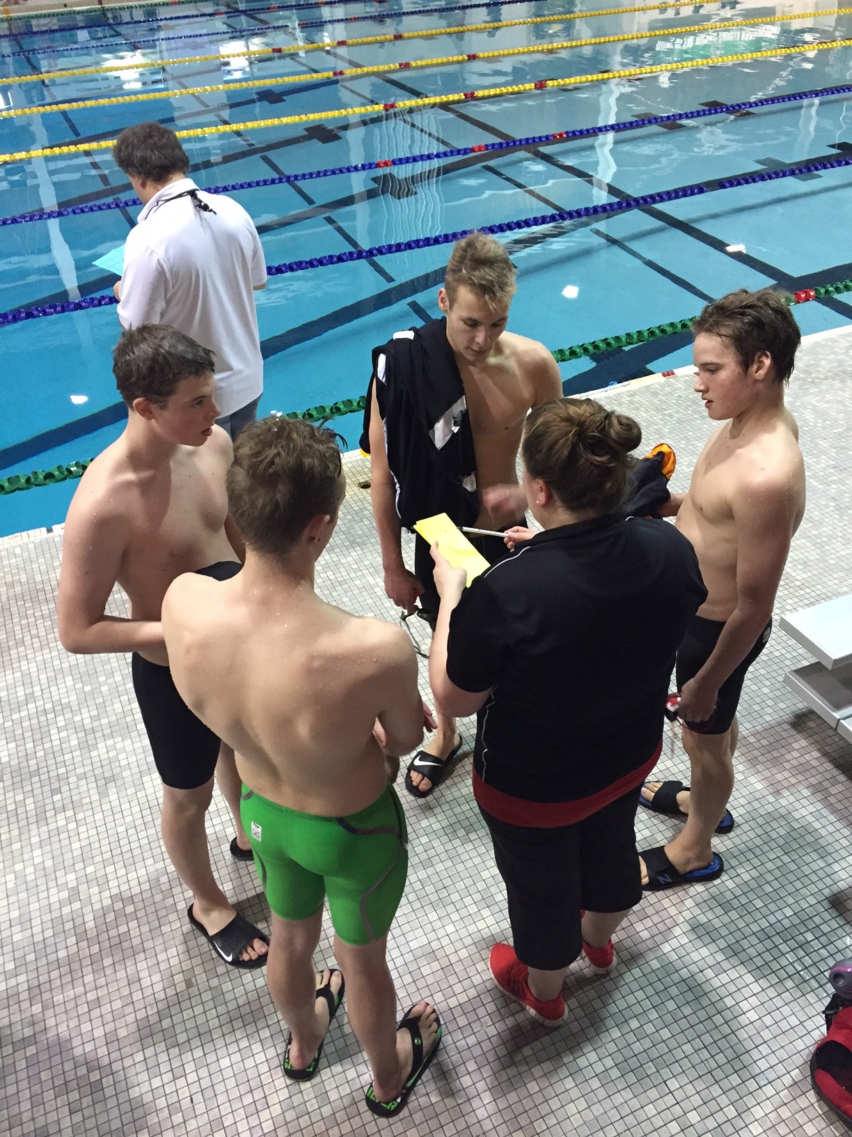 Coach Morgan gives post-race feedback to the relay team