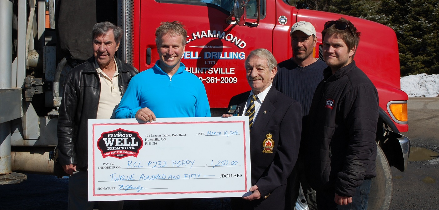 Staff from F.C. Hammond and draw winner Gord Cook present a cheque to Tony Evans of the Huntsville Legion