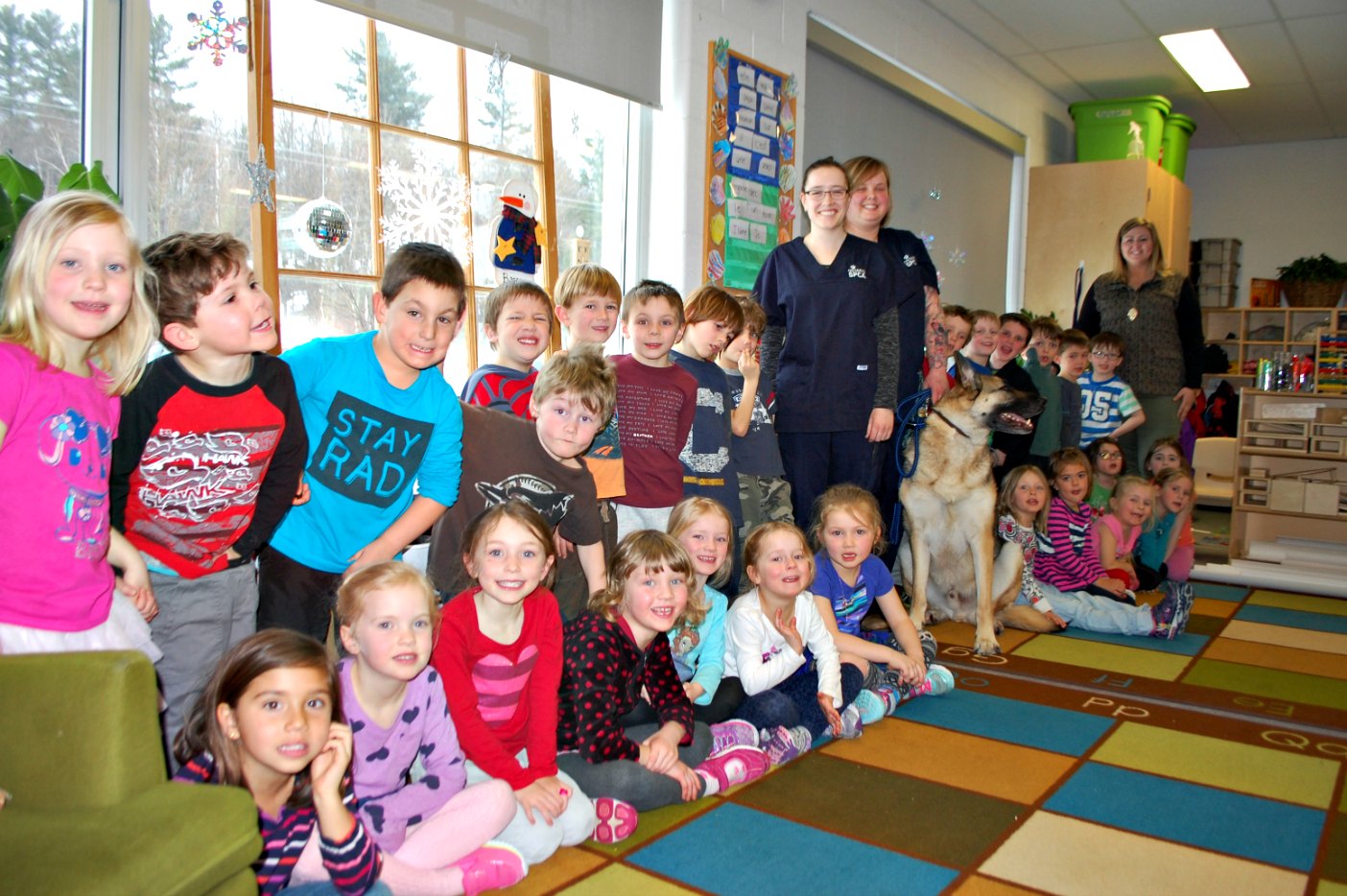 The Riverside SK French Immersion class with Jenna Blackall (centre left) and Kristy Kirk from the OSPCA, Kingsley the dog, and teacher Jessica McAlpine (far right)