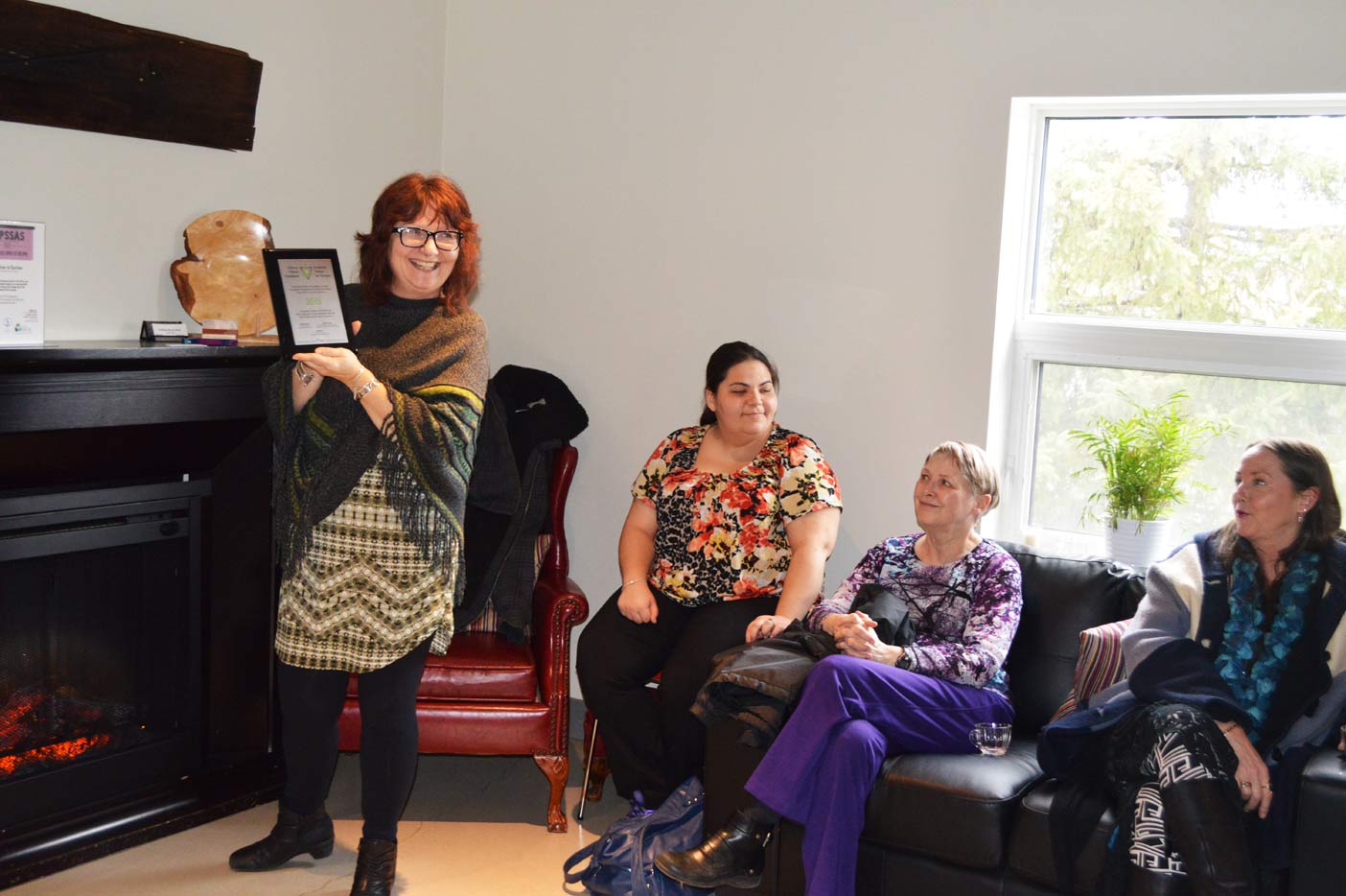 Lauren Power, executive director of Muskoka Parry Sound Sexual Assault Services, proudly holds a recognition plaque the agency received for a new mentorship program that will bring local sexual assault victims together. 