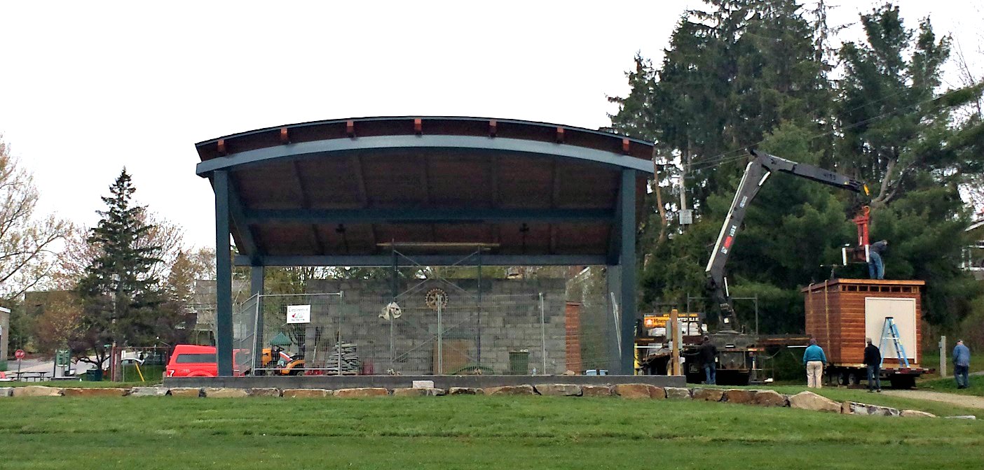 Crews are finishing the stonework and accessory buildings are being moved into place for the new River Mill Park Rotary Bandshell