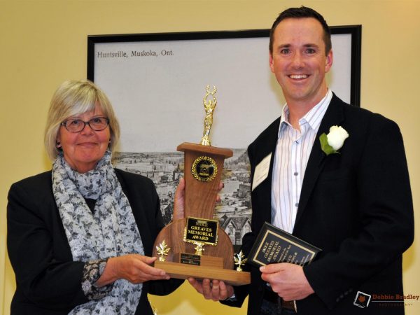 Peggy Hurley presenting the Mike Greaves award to Rich Trenholm