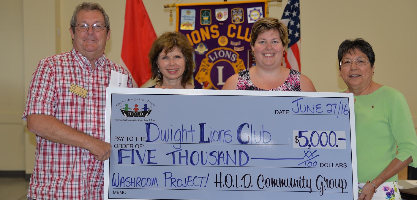 (From left) Joe Deniet, Karen Piovaty, Tanya Grainger and Nellie Sheshewabic with H.O.L.D.’s donation to the Dwight Beach public washroom project. (Photo: Jennifer Pilon)