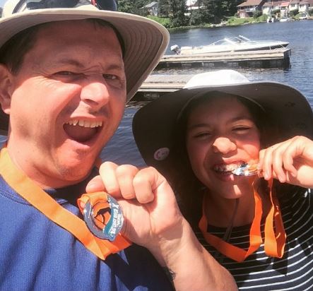 Matt and Bronwyn with their Big East River X medals in 2015. (Photo courtesy of Bacon or Bust.)