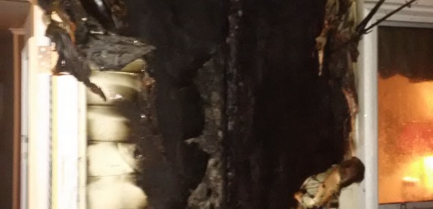 Fire caused by improperly discarded smoking materials spreads into attic