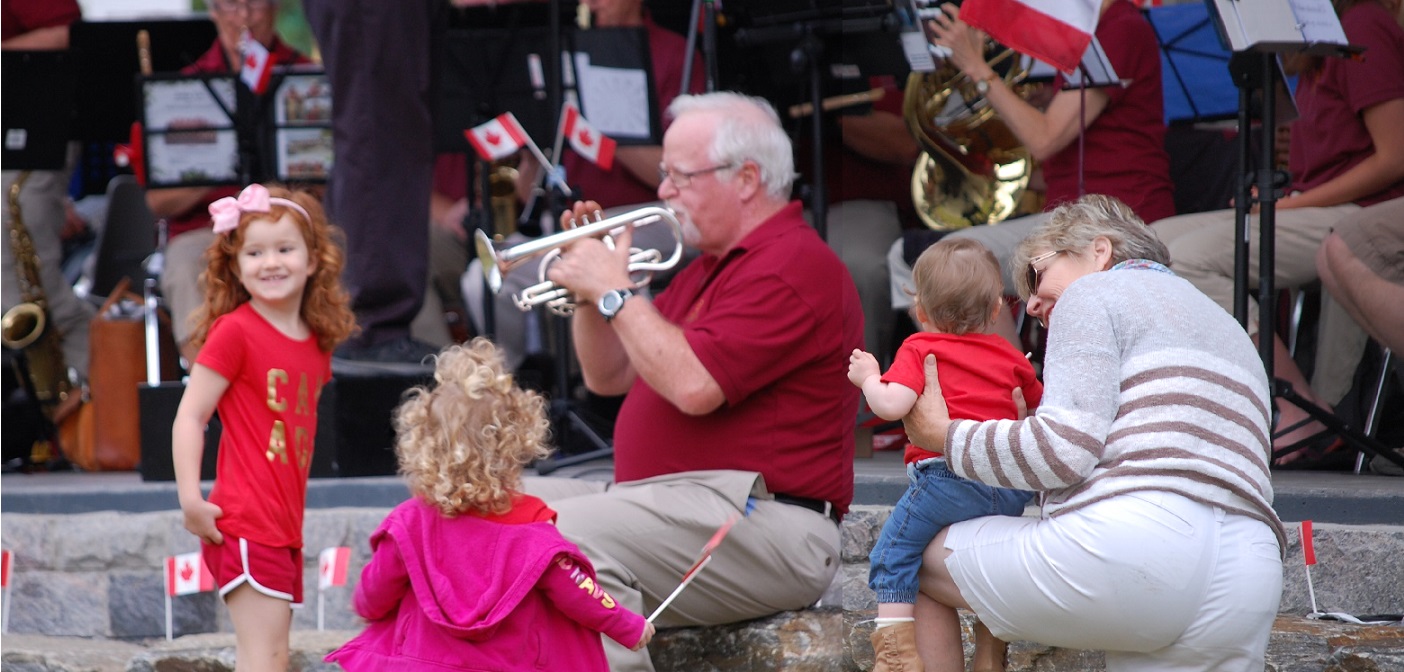 (Children from left) Charlotte and Olivia Rogers and Hadley Duncan listen to their Papa Gord Duncan’s solo with the Muskoka Concert Band