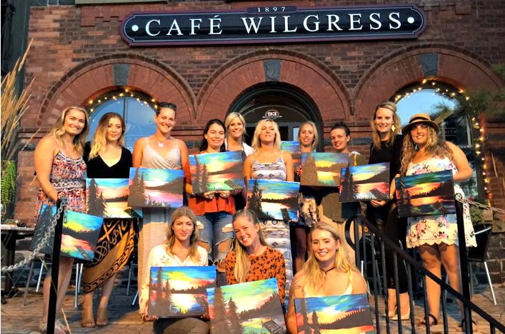 A Glass with Class participants with their finished paintings (Photo: Liz Norris)