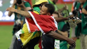 The fastest man in the world, Usain Bolt, embraces the next great Canadian sprinter Andre De Grasse at the finish line of the men's 100m final