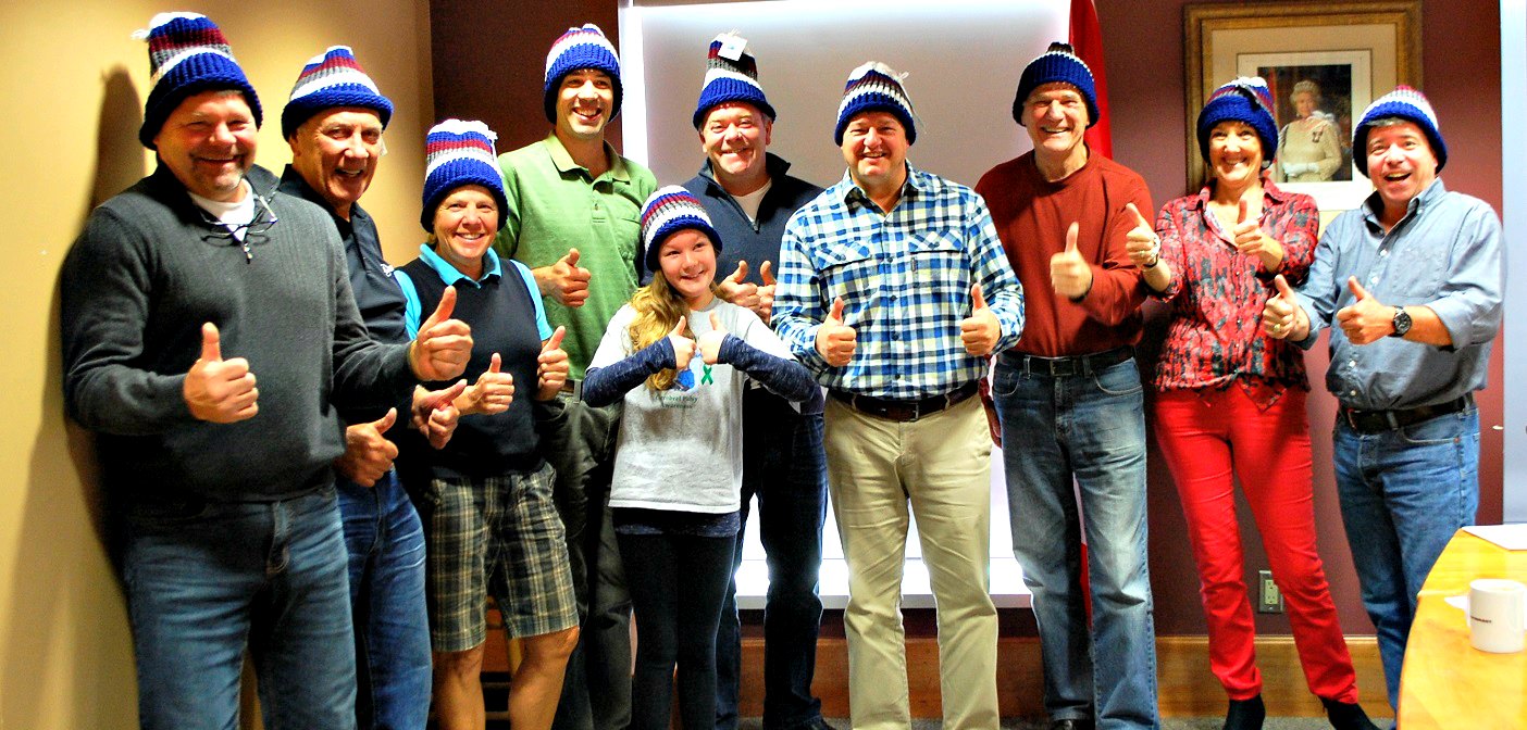 Kennedy Watson-Brown, centre front, with council members wearing the knitted hats she made