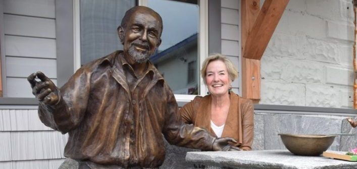 Artist Brenda Wainman Goulet, the creator of the affable George, sits by his side on a beautiful stone table and bench created by the talented Rudi Stade outside of Huntsville’s men’s shelter in 2016