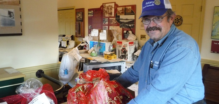 Peter Redwood from the Rotary Club of Huntsville with some of the Christmas auction items
