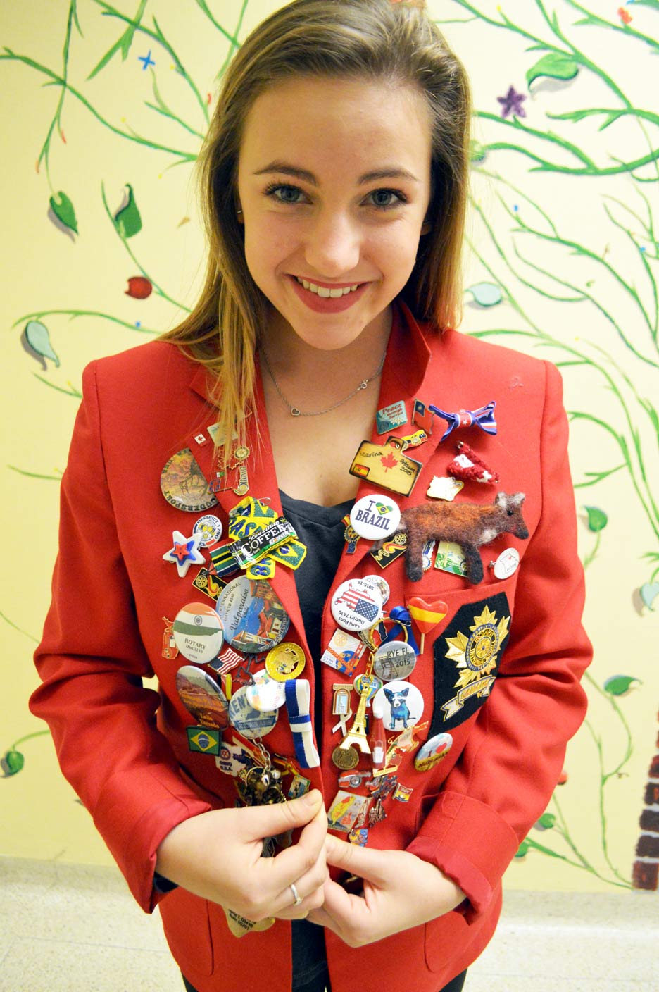 She wears her Rotary blazer with pride. Adorned with pins, each tell a story of a person she connected with or a place she's been. 