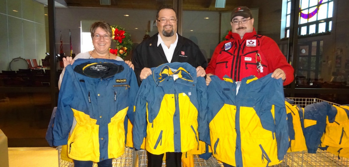 Karen Patterson, Rotary Interact facilitator, Major Darren Wiseman of the Salvation Army and Bradley Redwood of CSP Muskoka Zone proudly display three of the 35 jackets that have been donated to the Army’s winter clothing program.
