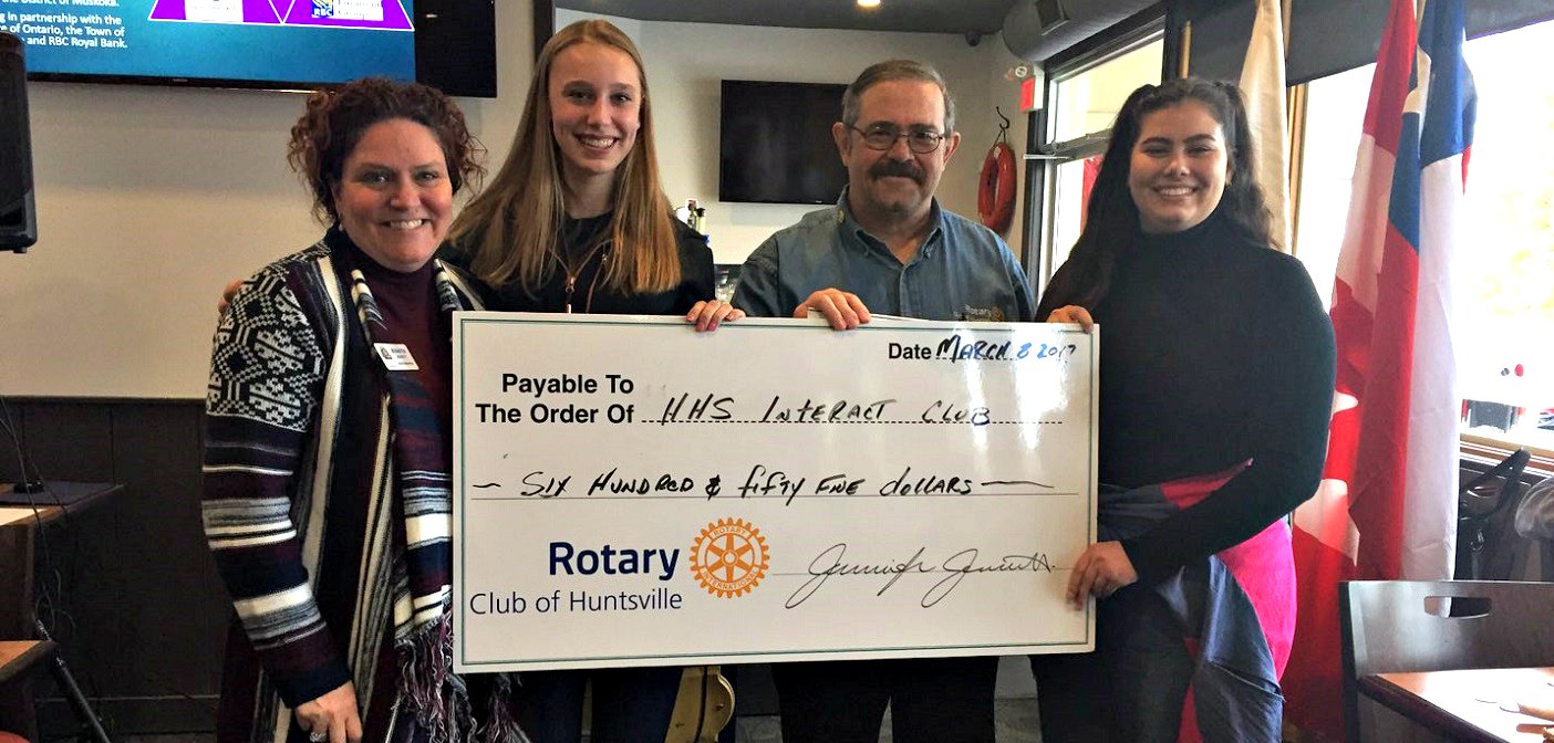 Rotarians Jennifer Jerrett (left) and Peter Redwood (second from right) present a cheque to Interact Club members Nicola DeRoode (second from left) and Chantel Musselman