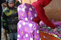 Egg hunters patiently awaited their turn to scoop from the wheelbarrow full of chocolate eggs
