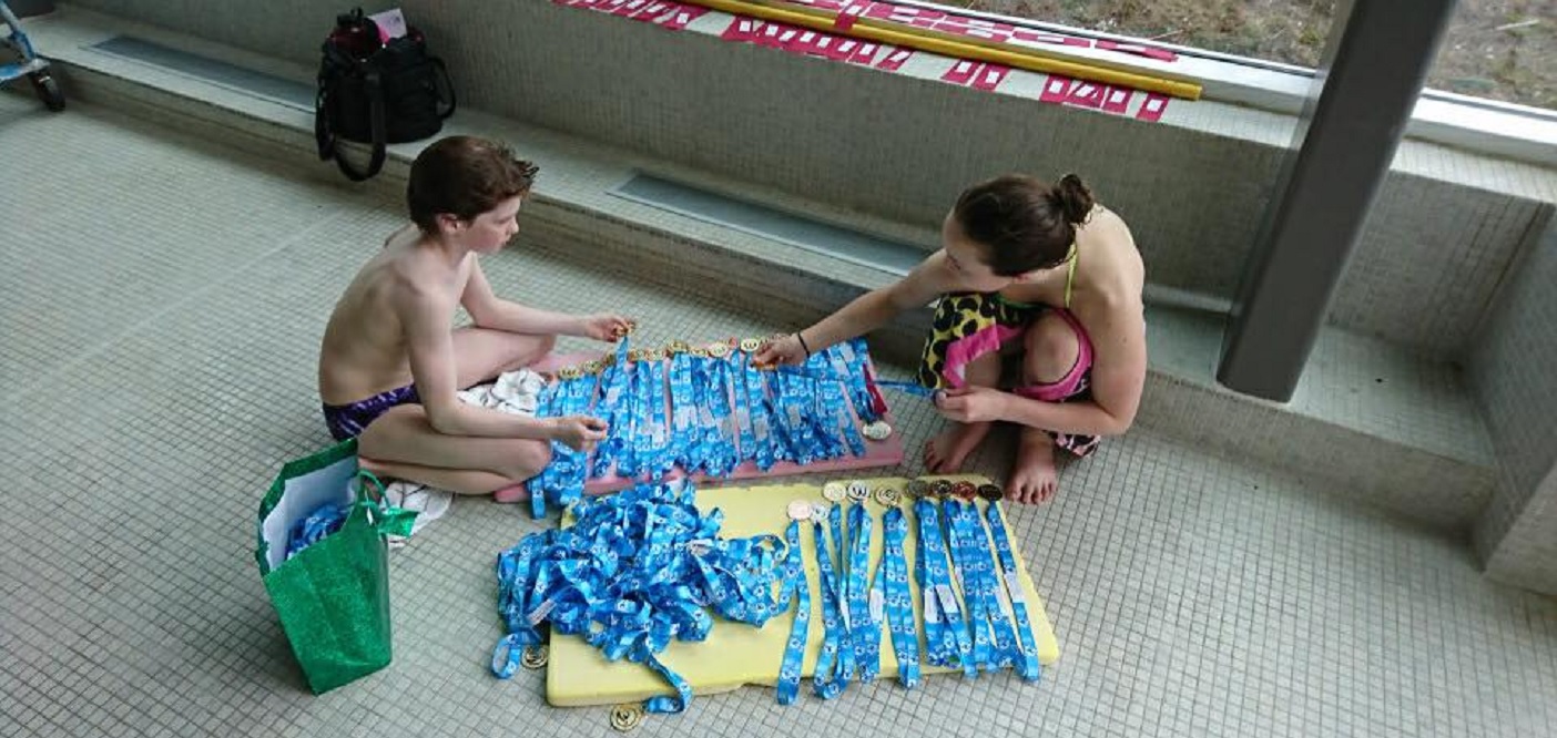 Ethan and Branwyn sort MUSAC Owen Sound Meet medals