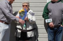 Mayor Scott Aitchison presents flowers to resident Anne Shorn who suggested that the swing bridge master's cabin needed repair