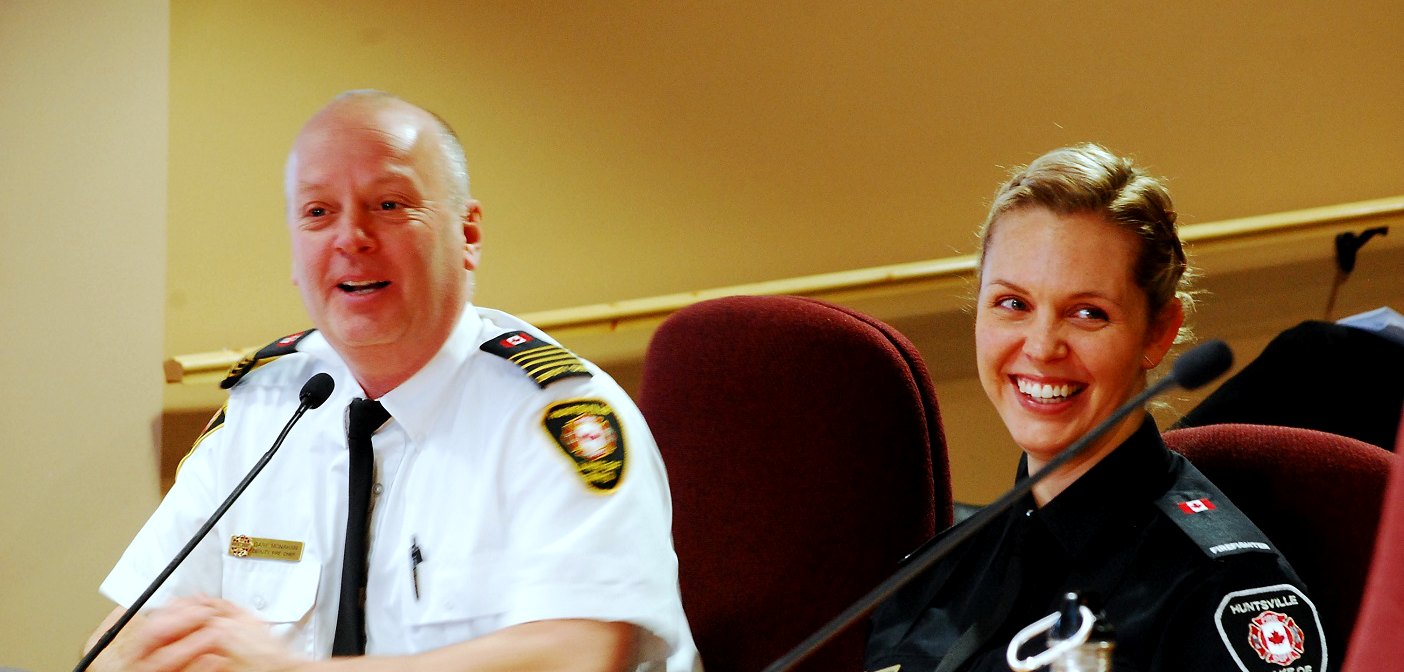 Deputy Fire Chief Gary Monahan (left) and volunteer firefighter Sabrina Lincoln introduce Huntsville's General Committee to Camp FFIT