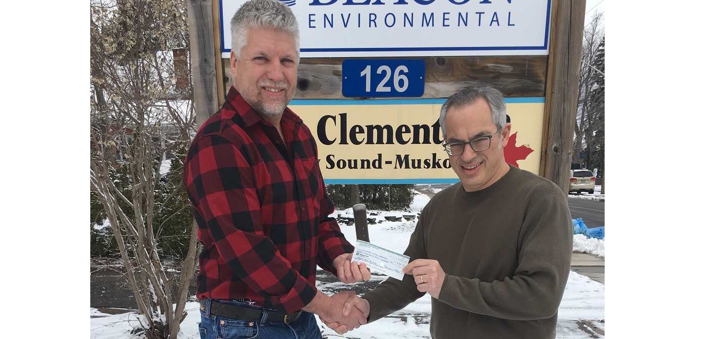 Muskoka Victim Services executive director Chris Eby (left) accept a cheque from MP Tony Clement on April 7