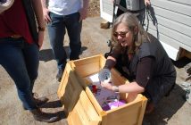 Teri Souter shows one of the more unusual items in the time capsule - a 1986 ashtray commemorating the 100th anniversary of the incorporation of the village of Huntsville