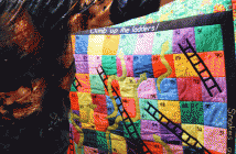 This baby blanket is truly one-of-a-kind. It can also be used by little ones to play the classic game of Snakes and Ladders. Yes, she hand-stitched the letters and numbers!