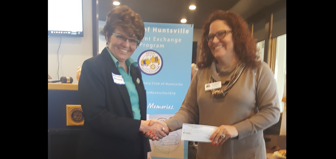 Marie-Louise Bechthold (left) accepts a cheque from Rotary Club of Huntsville president Jennifer Jerrett