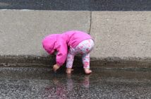 The rain provided some much needed entertainment for Hannah from Toronto as she waits for dad to return from the bike portion of the Tri.