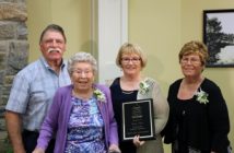 John Clayton (r) presents the plague inducting Roy Oke as a 'Builder' posthumously, to his widow, Blanche Oak-Guest and her daughters, June Hayworth and Donna Trumble.