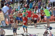 The 8-year-old males head into the transition area following the swim