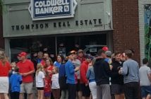 Volunteers gather outside Coldwell Banker Thompson Real Estate for their 22nd annual Canada flag planting