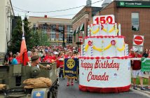 Parade-goers followed the birthday cake into River Mill Park