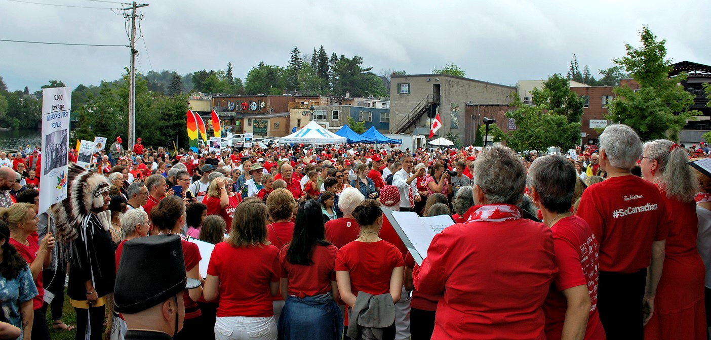 A 100-voice choir - a fringe initiative by Huntsville Festival of the Arts - sings out over a sea of red and white