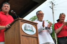 (From left) Mayor Scott Aitchison, MP Tony Clement and MPP Norm Miller wish the crowd a happy Canada Day