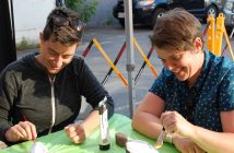 Marika Chandler (left) and Anna Gaby-Trotz paint stones in honour of Kareen