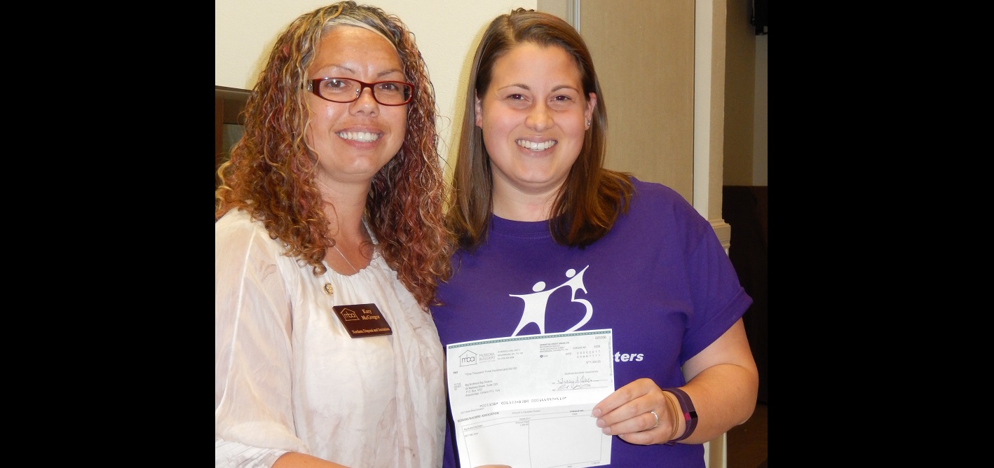 Katy McGregor (left), Vice-President of the Muskoka Builders’ Association, presents a cheque for $1,300 to Big Brothers Big Sisters of Muskoka (supplied photo)