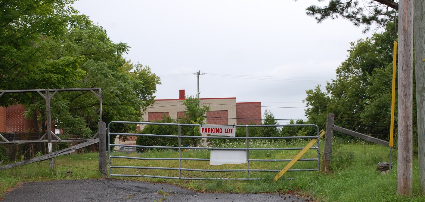 A gate at the Princess Street entrance to the property in question. The Algonquin Theatre is in the background.