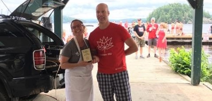 Reagan Gray accepts Citizen of the Year award from Port Sydney/Utterson & Area Chamber of Commerce Vice-President Derek Watson-Brown