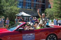 MP Tony Clement and Councillor Jonathan Wiebe wave to the crowd