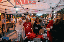 Stefan Ottenbrite gives the thumbs up while Jimmy Arnot, Jane Simpson and her daughter Dana check out some of the deals he was offering at his booth.