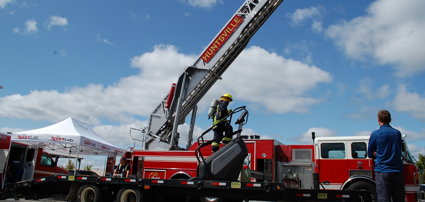 The SportLab’s Katherine Ahokas demonstrates the effort needed to climb stairs in firefighting gear