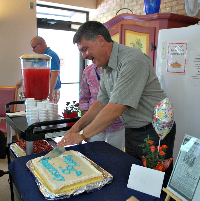 Fairvern's board chair Rob Laver cuts the anniversary cake