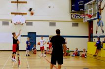 Seth Cooper takes a shot while coach Mike Hurley looks on