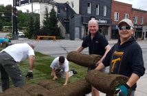 Neil Surman from the U.K. (left, with Matt Huddlestone) took time out of his vacation to help lay sod