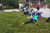Nancy Osborne takes a minute to enjoy Main Street's new grass