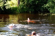 Joy (left) makes the final few strokes to the Town Dock accompanied by Nancy Alcock (back) and Rebecca Francis