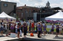 Swimmers and spectators cheer on Joy as she completes her 12km swim