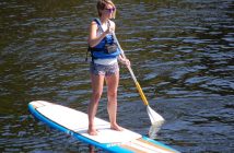 Rebecca Ellerson keeps a close eye on the swimmers from her stand up paddle board